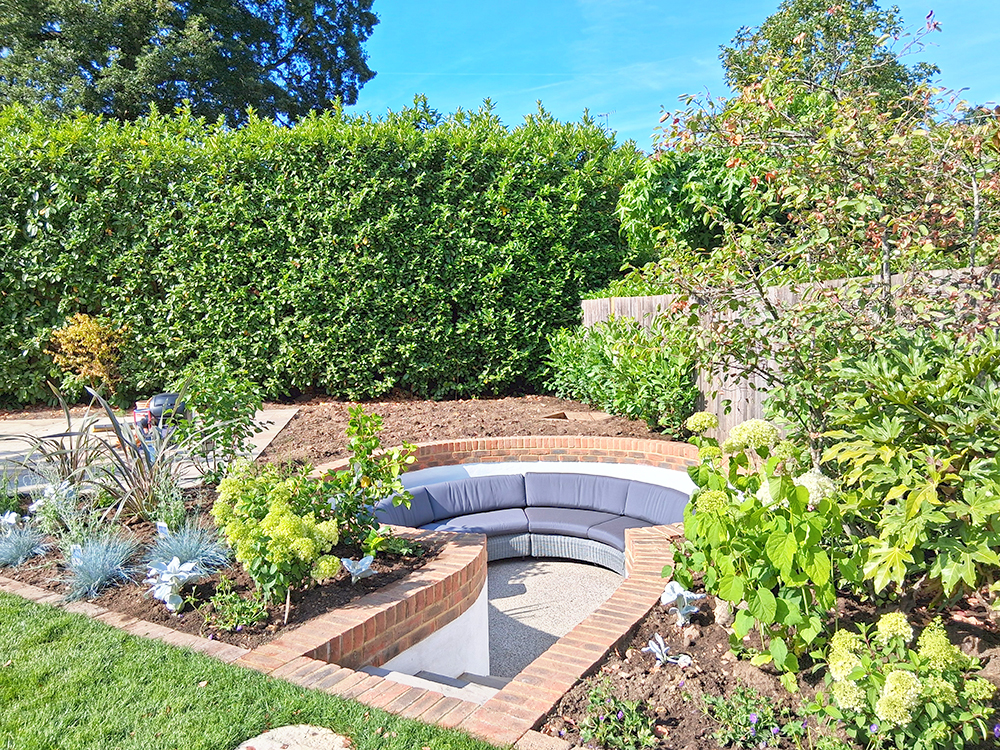 Sunken seating area with newly planted beds