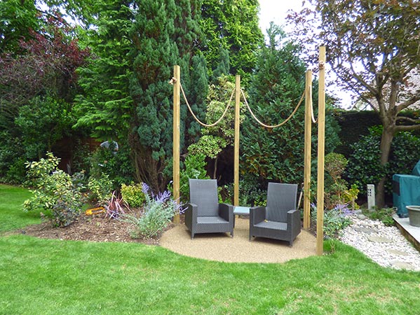 Arbour with outdoor seating on bonded gravel base